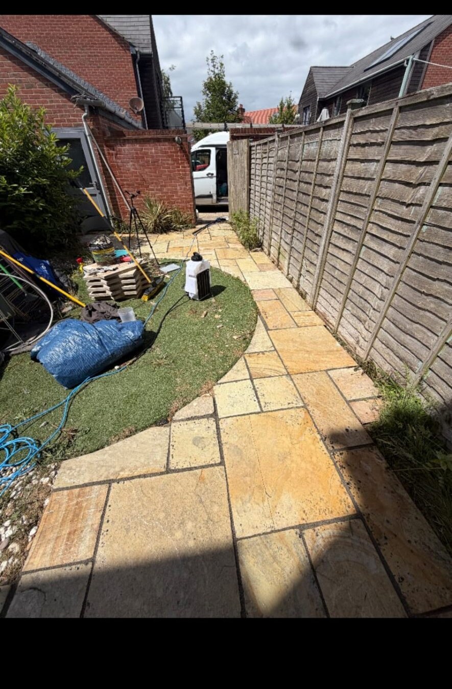 Sandstone patio mid re-grouting job with joints being prepped on a Hampshire property
