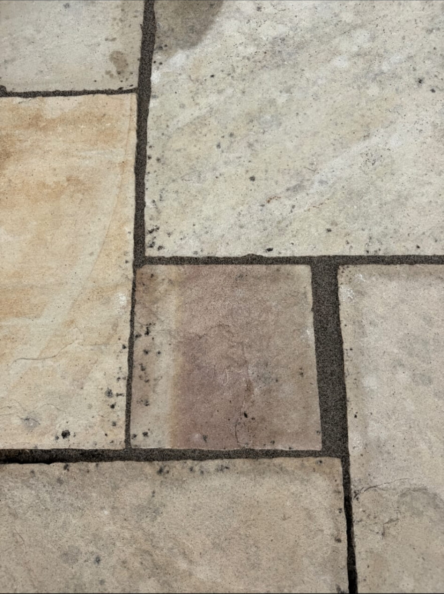 Sandstone patio joints re-grouted — weeds, moss and failed pointing replaced with fresh mortar after cleaning